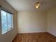 Bedroom with wood floors, ceiling fan, and a window at 1483 Prairie Ter, North Port, FL 34286