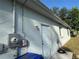 Exterior view of the home, including a side door and utility access at 1483 Prairie Ter, North Port, FL 34286