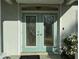 Close-up of elegant glass double doors, offering a grand entrance and enhanced curb appeal at 1483 Prairie Ter, North Port, FL 34286