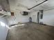 Open garage with a water heater, shelving, and access door to the home at 1483 Prairie Ter, North Port, FL 34286
