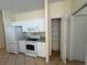 Kitchen area with white appliances, pantry, and matching cabinets at 1483 Prairie Ter, North Port, FL 34286