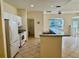 Kitchen featuring white appliances, cabinets, and a breakfast bar overlooking the dining area at 1483 Prairie Ter, North Port, FL 34286