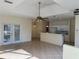 Bright, open-concept living space with tile flooring, neutral walls, and access to the kitchen at 1483 Prairie Ter, North Port, FL 34286