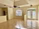 Open-concept living room with tile floors, ceiling fan, and natural light at 1483 Prairie Ter, North Port, FL 34286