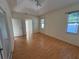 Large main bedroom with laminate flooring, ceiling fan, and windows providing ample natural light at 1483 Prairie Ter, North Port, FL 34286