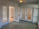 Spacious porch with ceiling fan, large sliding doors to home interior at 1483 Prairie Ter, North Port, FL 34286