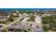 Beautiful aerial view of the condo complex with lush landscaping, community pond, and Gulf views at 1730 Manasota Beach Rd # 212, Englewood, FL 34223