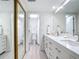 Bathroom boasts a double vanity, sleek mirrors, and updated finishes at 1730 Manasota Beach Rd # 212, Englewood, FL 34223
