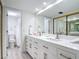 Well-lit bathroom with double sinks, vanity, and modern fixtures at 1730 Manasota Beach Rd # 212, Englewood, FL 34223