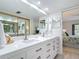 Bathroom featuring a large mirror over double sinks, connecting to the bedroom at 1730 Manasota Beach Rd # 212, Englewood, FL 34223