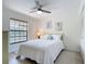 Cozy bedroom with a large window and neutral color scheme at 1730 Manasota Beach Rd # 212, Englewood, FL 34223