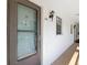 Exterior entrance to Unit 212 featuring a brick floor, light fixtures, and a brown door at 1730 Manasota Beach Rd # 212, Englewood, FL 34223