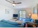 Bright living room with a sliding glass door and contemporary furnishings at 1730 Manasota Beach Rd # 212, Englewood, FL 34223