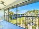 View from the screened patio showcasing the lush greenery, tropical plants, and blue skies at 1730 Manasota Beach Rd # 212, Englewood, FL 34223