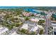 Scenic aerial view of city with lush greenery, waterway, buildings, and roadways at 1833 Raintree Ln, Venice, FL 34293