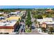 Aerial view of a picturesque downtown street lined with trees, buildings, and passing vehicles at 1833 Raintree Ln, Venice, FL 34293
