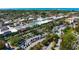 Aerial view showcasing the city's buildings, streets, trees, and parking areas near the ocean at 1833 Raintree Ln, Venice, FL 34293
