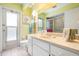 A well-lit bathroom features a white vanity, shower, and tiled floors, complemented by colorful accents and natural light at 1833 Raintree Ln, Venice, FL 34293