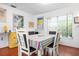 Bright dining room with a table set for four and a sunlit window at 1833 Raintree Ln, Venice, FL 34293