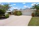 Charming single story home with a well maintained lawn, lush landscaping and a circular driveway at 1833 Raintree Ln, Venice, FL 34293