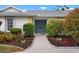 Inviting front entrance with a double door entry, mature landscaping and a well maintained walkway at 1833 Raintree Ln, Venice, FL 34293