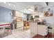 Bright eat-in kitchen with tiled floors, cream cabinets, an island, and stainless steel appliances at 1833 Raintree Ln, Venice, FL 34293