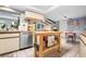 Kitchen features a functional island and stainless steel appliances, open to the living area at 1833 Raintree Ln, Venice, FL 34293