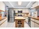 Modern kitchen features stainless appliances, a functional island, and plenty of cabinet space at 1833 Raintree Ln, Venice, FL 34293