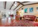 Wide open living room with dining room and kitchen views, and beamed vaulted ceilings at 1833 Raintree Ln, Venice, FL 34293