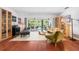 Bright and open living room featuring wood floors and sliding glass doors leading to the pool area at 1833 Raintree Ln, Venice, FL 34293