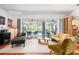 Bright and open living room featuring wood floors and sliding glass doors leading to the pool area at 1833 Raintree Ln, Venice, FL 34293