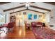 Open floor plan living room with a stone fireplace, vaulted ceilings, and access to the dining room at 1833 Raintree Ln, Venice, FL 34293