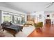 Bright and open living room featuring wood floors and sliding glass doors leading to the pool area at 1833 Raintree Ln, Venice, FL 34293