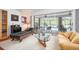 Bright and open living room featuring wood floors and sliding glass doors leading to the pool area at 1833 Raintree Ln, Venice, FL 34293