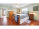 Main bedroom with hardwood floors, large window and ensuite bathroom at 1833 Raintree Ln, Venice, FL 34293