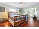 Bright main bedroom featuring wood floors, ceiling fan and access to the pool at 1833 Raintree Ln, Venice, FL 34293