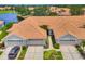 Clean aerial shot of these light-colored homes with a lake view in the neighborhood at 1892 San Silvestro Dr, Venice, FL 34285