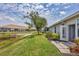 Charming backyard view with a well-manicured lawn, privacy landscaping and a peaceful pond outlook at 1892 San Silvestro Dr, Venice, FL 34285