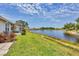 This tranquil backyard view showcases a pristine lake and lush green lawn, creating an inviting outdoor space at 1892 San Silvestro Dr, Venice, FL 34285