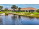 Scenic backyard view showcases a lush lawn and tranquil lake, perfect for outdoor relaxation and entertaining at 1892 San Silvestro Dr, Venice, FL 34285