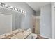 Well-lit bathroom featuring double sinks and a glass-enclosed shower at 1892 San Silvestro Dr, Venice, FL 34285