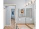 Bathroom with a view to bedroom, vanity with large mirror and tile floors at 1892 San Silvestro Dr, Venice, FL 34285
