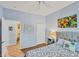 Well-lit bedroom with queen bed, tile flooring, closet, and ensuite bathroom access at 1892 San Silvestro Dr, Venice, FL 34285