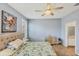 Comfortable bedroom with shutters, ceiling fan, and neutral paint at 1892 San Silvestro Dr, Venice, FL 34285