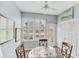 Bright breakfast nook featuring shuttered windows, ceiling fan and a cozy round table for enjoying morning meals at 1892 San Silvestro Dr, Venice, FL 34285
