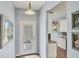 Bright entryway with tile floors, glass paneled door, and views into the kitchen at 1892 San Silvestro Dr, Venice, FL 34285
