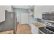 Bright kitchen with stainless steel appliances, granite countertops, and mosaic tile backsplash at 1892 San Silvestro Dr, Venice, FL 34285
