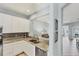Bright kitchen with white cabinets, granite countertops, and stainless steel appliances at 1892 San Silvestro Dr, Venice, FL 34285