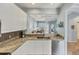 Bright kitchen featuring granite countertops, stainless steel appliances, and pass through window at 1892 San Silvestro Dr, Venice, FL 34285