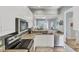 Bright kitchen featuring granite countertops, stainless steel appliances, and tile backsplash at 1892 San Silvestro Dr, Venice, FL 34285